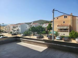 - un balcon avec vue sur le parking dans l'établissement Thἕros Exceptional Residence, à Néa Péramos