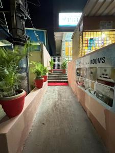 a store hallway with potted plants and a red carpet at Vbh Inn- Affordable and Budget Friendly in Jigani +53 photos