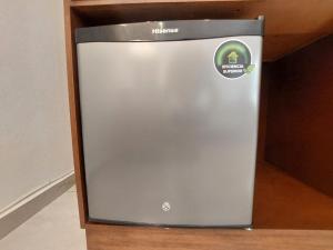 a metal refrigerator sitting on top of a shelf at Casa Allende Morelia in Morelia