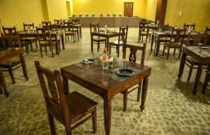 The Carvaans Resort في جيلسامر: غرفة طعام فارغة مع طاولات وكراسي