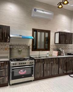 a kitchen with a stove and a sink at Oxygen hatta in Hatta