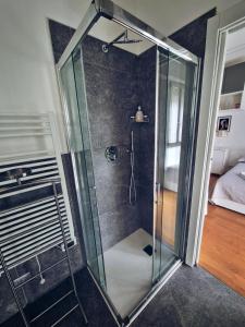a shower with a glass enclosure in a bedroom at A UN PASSO DALL'OSPEDALE in Padova