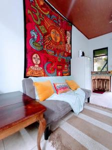 a living room with a couch and a colorful wall at Nirvana Apartament Hostal in Alajuela City