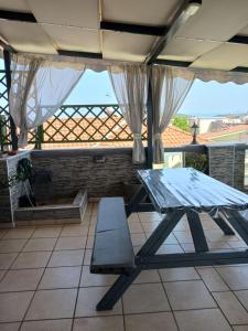 a picnic table on a patio with a roof at Green House in Néa Péramos