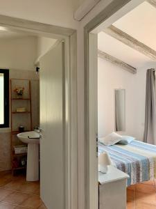 a bedroom with a bed and a sink at La Casa di Alice Turchese in Olbia