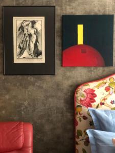 a living room with a red couch and pictures on the wall at Olga apartment in Rīga