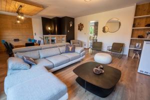 a living room with a couch and a table at Chalet Gaïla in Méribel