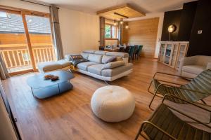 a living room with a couch and a table at Chalet Gaïla in Méribel
