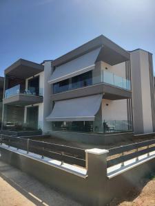 a large building with awning on the side of it at ἕαR Exceptional Residence in Nea Peramos