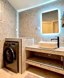 a bathroom with a washing machine and a sink at Kefi House Skiathos in Skiathos