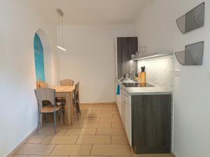 a kitchen with a table and a dining room at Apartments Abc Ljubljana in Ljubljana