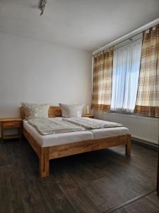 a bedroom with a large bed in front of a window at Ferienwohnung Mond&Wasser 2 in Norden