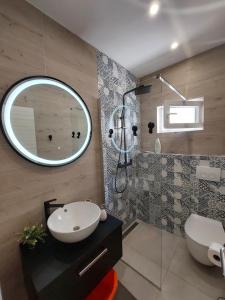 a bathroom with a sink and a mirror at Apartman MariLu in Drašnice