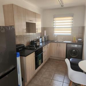 a kitchen with a stove and a dishwasher at Two Bedroom townhouse THE PINES ALBERTSDAL in Alberton