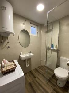 a bathroom with a toilet and a sink and a shower at Apartman Copacabana in Krašići