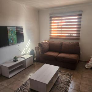 a living room with a couch and a coffee table at Two Bedroom townhouse THE PINES ALBERTSDAL in Alberton