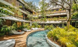 an indoor garden with a swimming pool in a building at Divine 1BR PH with Private Pool and Spectacular Pools in Tulum