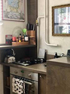 a kitchen with a stove top oven next to a counter at Olga apartment in Rīga