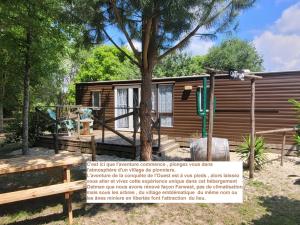 a tiny house with a sign in front of it at Camping Syl-Vallée Western Village in Bouglon