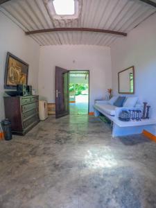 a large room with a bed and a dresser at Finca San Cayetano - Minca in Arimaca