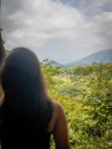 a woman looking out at a view of a valley at Finca San Cayetano - Minca in Arimaca