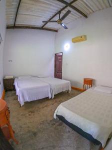 a bedroom with two beds in a room at Finca San Cayetano - Minca in Arimaca