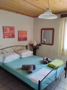 a bedroom with a bed with towels on it at spitaki in Kavala