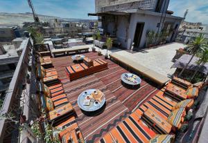 an outdoor patio with tables and chairs on a building at Le Riad Giza Pyramids Hotel in Cairo