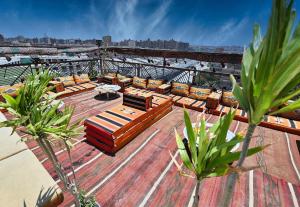 a deck with couches and a view of a city at Le Riad Giza Pyramids Hotel in Cairo