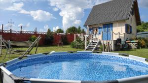 a large swimming pool in front of a house at Skotopaska & Bukolika in Idzbark