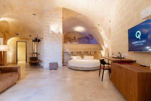Ένα ή περισσότερα κρεβάτια σε δωμάτιο στο BV Quarry Matera