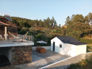 a view of a white building with a patio at Casa de baixo studios in Arouca