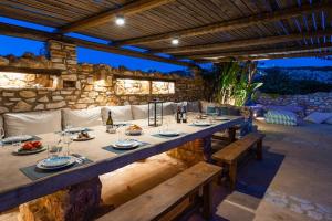 a long wooden table with plates of food on it at BLUE VILLA in Kampos Paros