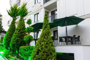 a balcony with a table and an umbrella at North Star Suite Hotel in Trabzon