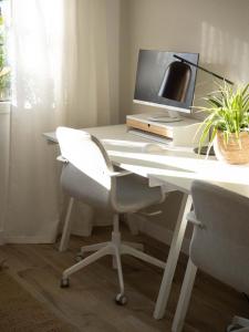 a white desk with a computer monitor and a chair at Luxury Apartment in Valencia City center in Valencia