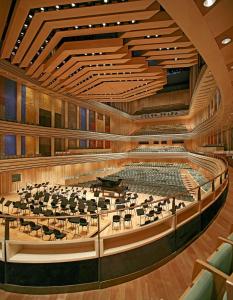 an auditorium of a concert hall with a grand piano at Sissy20 Apartman in Budapest