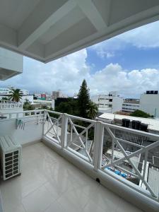 a balcony with a white railing and a view of a city at Edificio Santa Catalina in San Andrés