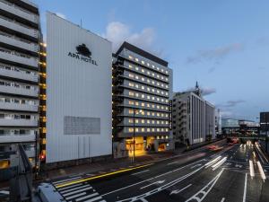 a building with aania on it on a city street at APA Hotel Kyoto Eki Horikawadori in Kyoto