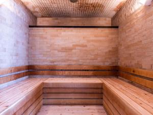 an empty sauna with wooden floors and a brick wall at APA Hotel Kyoto Eki Horikawadori in Kyoto