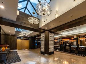 a lobby of a restaurant with chandeliers at APA Hotel Kyoto Eki Horikawadori in Kyoto