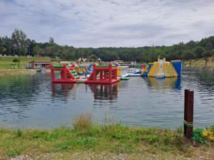 a group of colorful inflatable boats in a lake at Domaine Royal Quercy in Monclar-de-Quercy