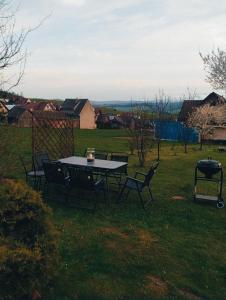 a table and chairs in a yard with a view at Pokój typu studio nr 2 in Sromowce Wyżne