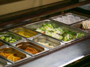 a buffet filled with trays of different types of food at APA Hotel Kyoto Eki Horikawadori in Kyoto