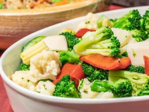 a bowl of broccoli and vegetables on a table at APA Hotel Kyoto Eki Horikawadori in Kyoto