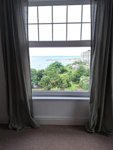 a window in a room with a view of the ocean at Seasalt Loft in Barmouth