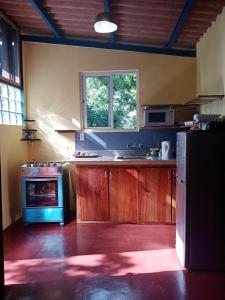 a kitchen with a blue stove and a refrigerator at Hotel Anachoreo in Santa Fe