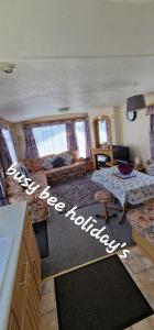 a large living room with a bed and a table at The Hive on The Chase Ingoldmells in Skegness