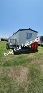 a house with a sign that reads just be holidays at The Hive on The Chase Ingoldmells in Skegness