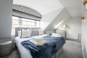 a bedroom with a large bed with towels on it at RÌGH Properties - Luxurious City Centre Three Bedroom Apartment in Edinburgh