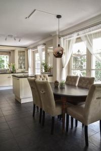 a kitchen and dining room with a table and chairs at The Cosy Cottage in Zeewolde